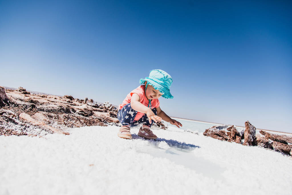 Toddler playing with salt at Lagunas Escondidas de Baltinache