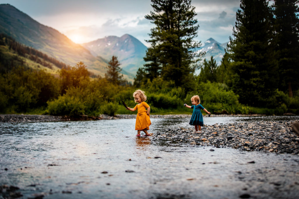 Kids playing with rocks at a creek in Crested Butte