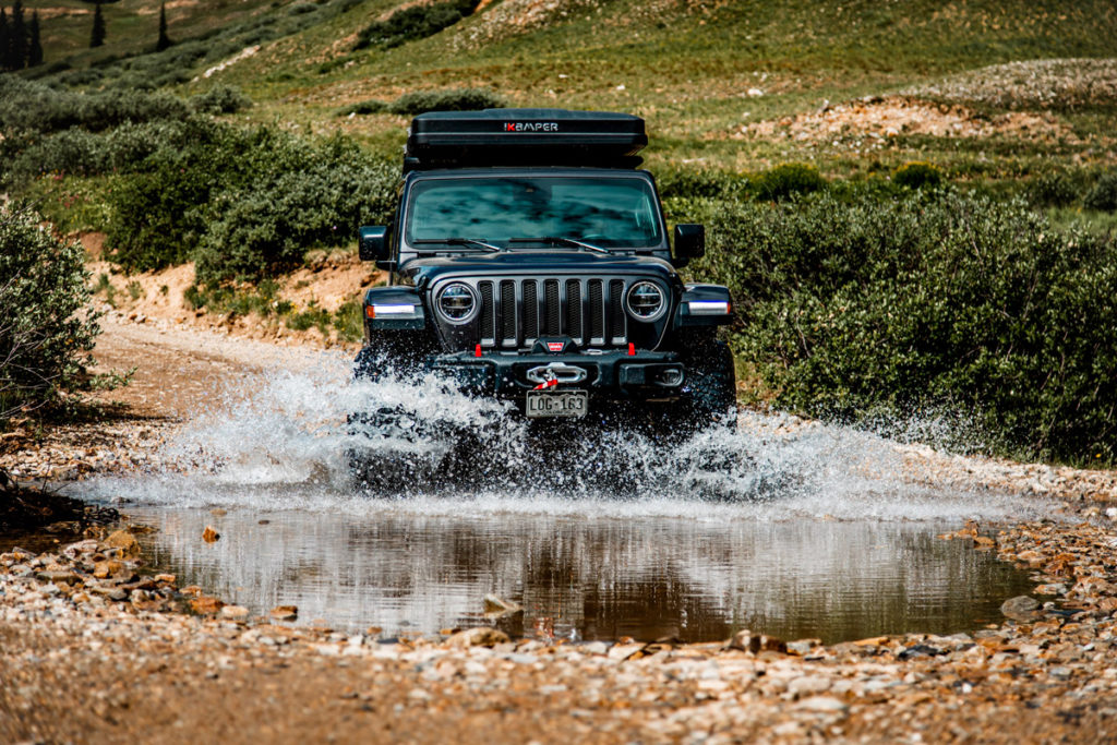 Jeep driving through rough terrain