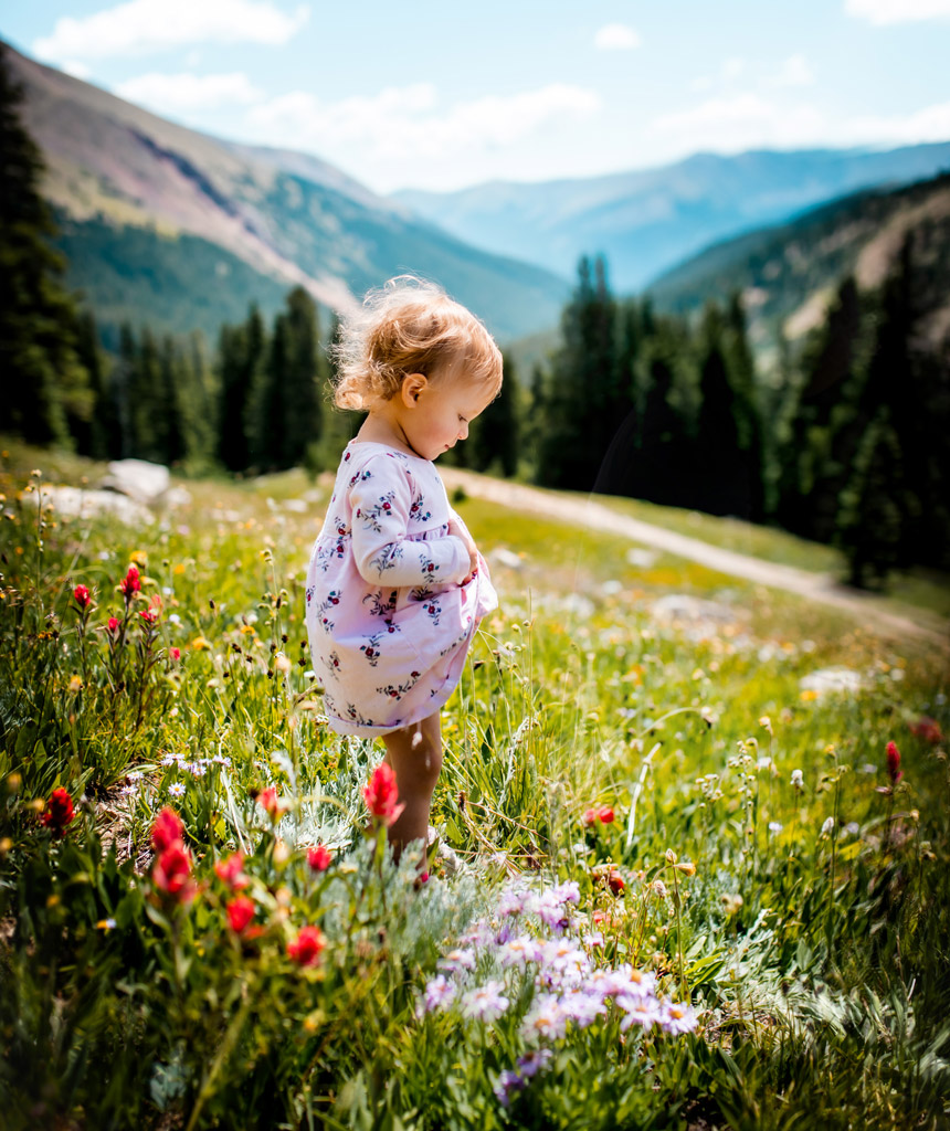Toddler standing in a field of wildflowers at Herman Gulch